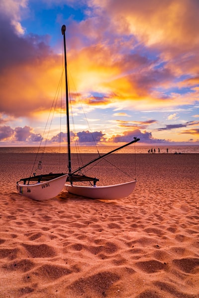 Brown white boats on the beach at sunset
